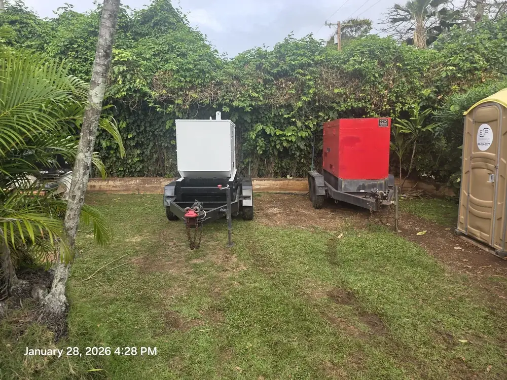 White and red generators set up on grass